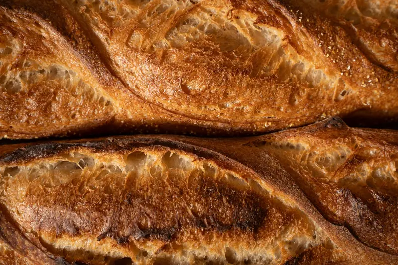 Detailed texture of golden crusted artisan baguettes fresh from the oven