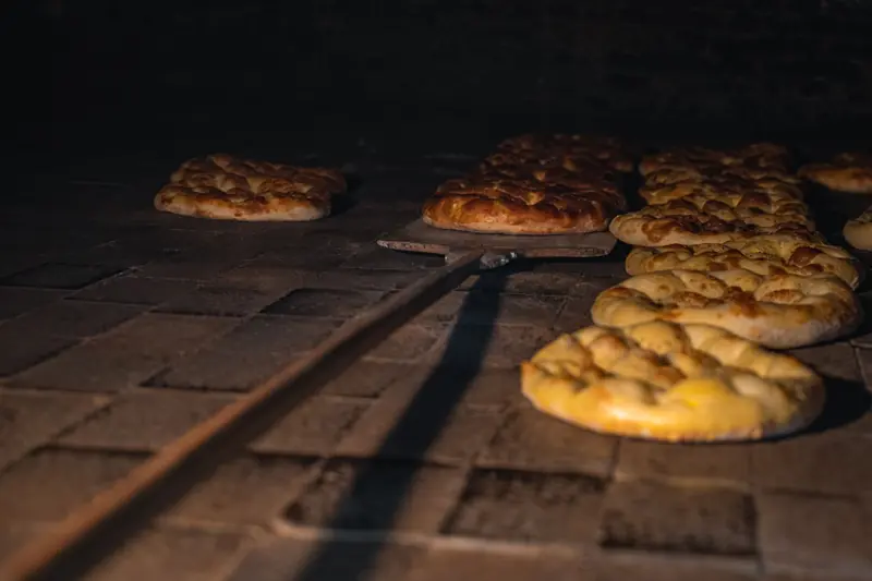 Golden brown loaves in a traditional stone oven, capturing the essence of artisanal bread making